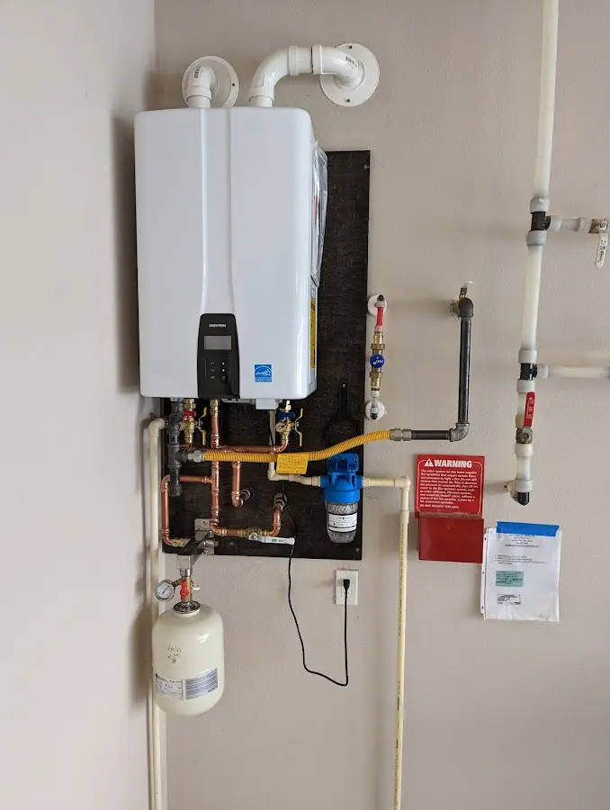 Professional plumber installing copper piping in a Piedmont home